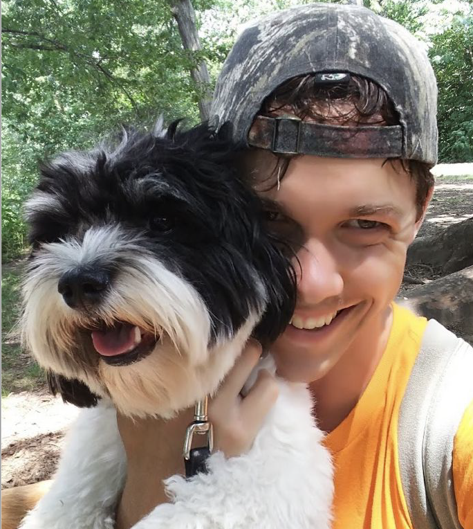 A Houndry team member taking a selfie with a dog